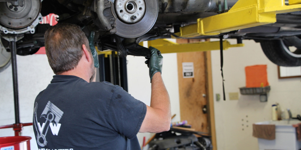 Image Of Mechanic Fixing The Brake